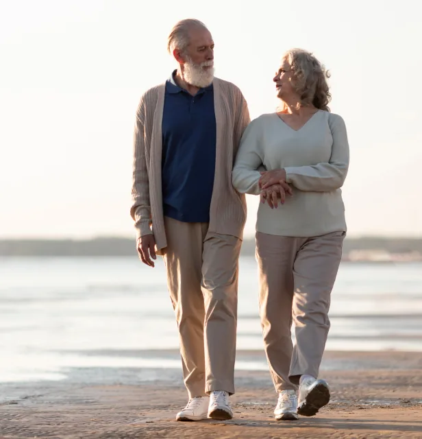 An older couple walking together outdoors